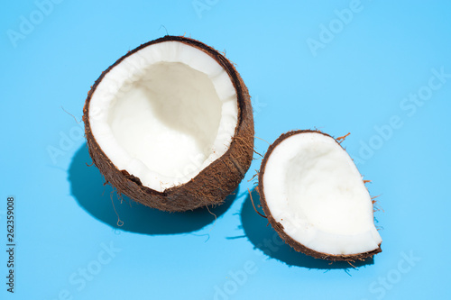 Fresh juicy coconut isolated on a blue background. Concept of Healthy eating and dieting. Travel and holiday concept