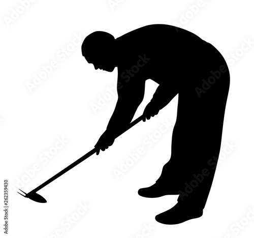 Man working in the garden with weeding hoe