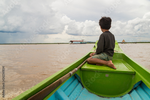 Cambodian child on a boat over Tonle Sap Lake, Cambodia