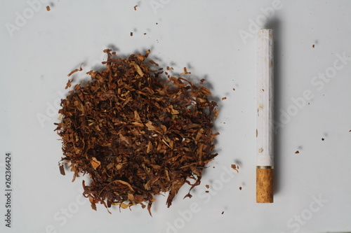 Cigarette and tobacco on white background