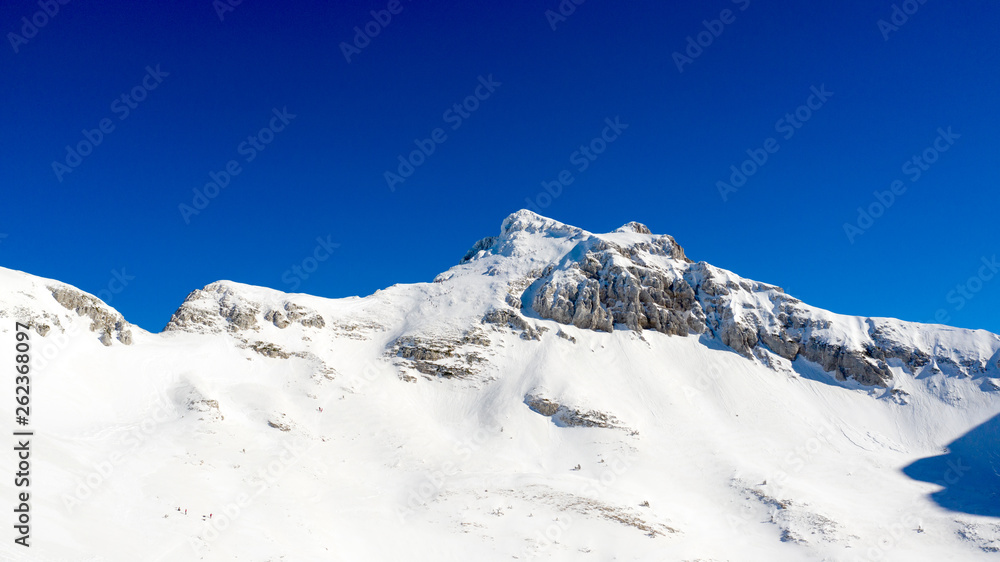 Winter landscape with the mountain peaks covered by heavy snow. Aerial view by drone. Winter landscape with the mountain peaks covered by heavy snow. Aerial view by drone.