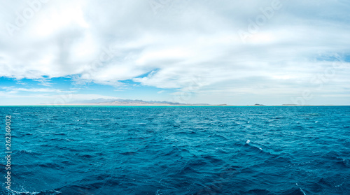 Panoramic photo on the background, blue sea with mountains on the background. © Алексей Еремеев