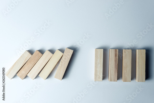 Falling wooden cubes  as a symbol of defeat  wrong decision and collapse  on an uneven white background. Horizontal frame