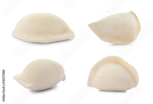 Set of delicious raw dumplings on white background