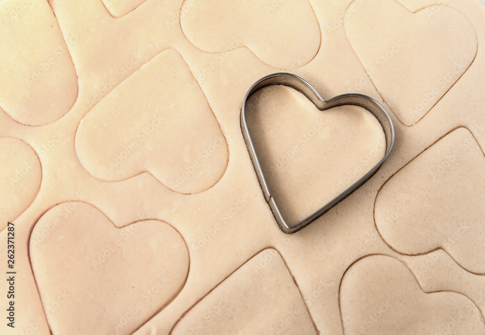 Obraz premium Dough for cookies. A mold for cutting cookies in the form of heart. St. Valentines Day. Top view