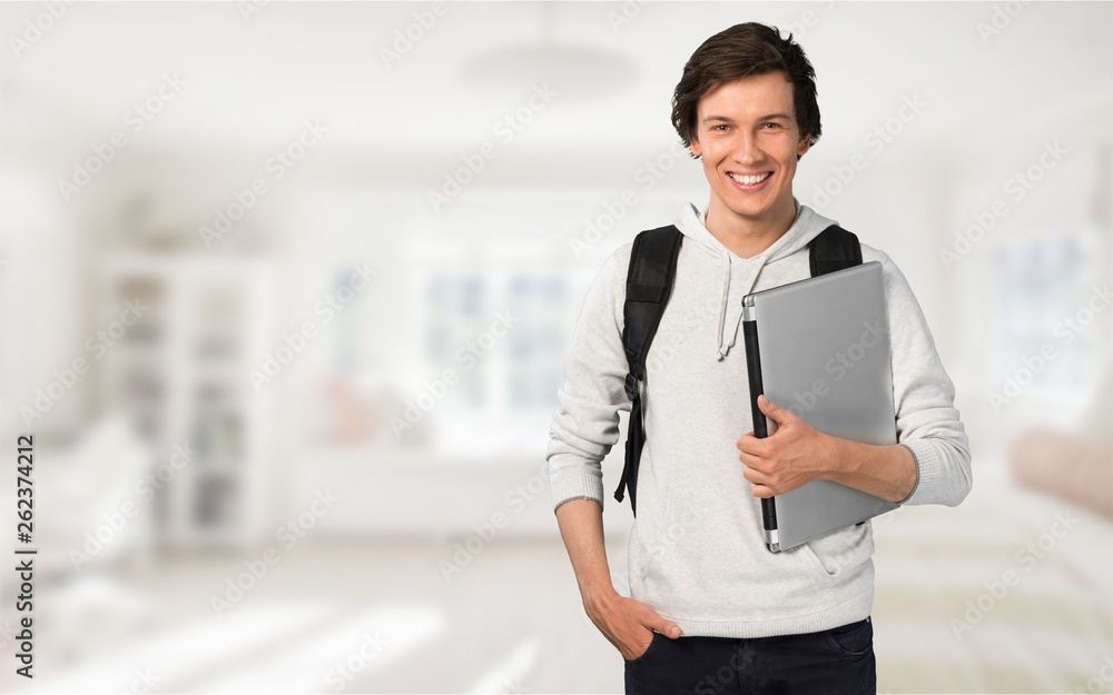 Smiling African Student man with laptop, mall background, bokeh Smiling African Student man with laptop, mall background, bokeh