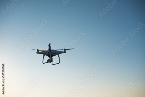 Fototapeta Naklejka Na Ścianę i Meble -  White drone fly in the sky recording a video