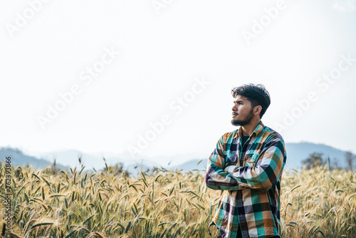 Handsome man farmer with barlay field