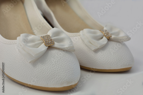 A white female shoes with a bow