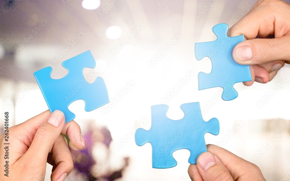 Hands of woman and man holding puzzles Hands of woman and man holding puzzles