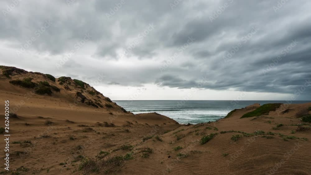 Time Lapse: Stormy Gray Clouds Passing Over Sand Dunes and Wave Filled Ocean in Monterey, California Time Lapse: Stormy Gray Clouds Passing Over Sand Dunes and Wave Filled Ocean in Monterey, California