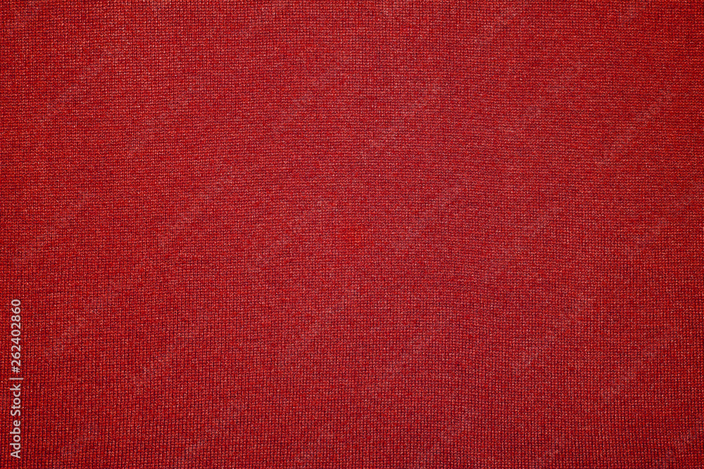 The texture of the knitted red fabric for the background The texture of the knitted red fabric for the background
