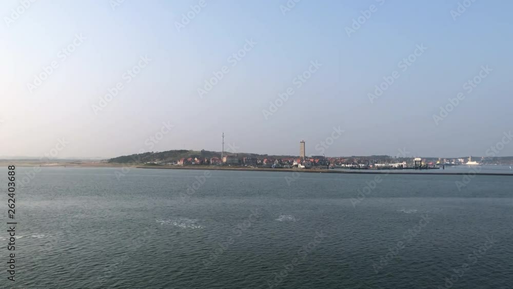 Aerial shot of the island of the Dutch Terschelling in the Netherlands with iconic lighthouse landmark named Brandaris. Aerial shot of the island of the Dutch Terschelling in the Netherlands with iconic lighthouse landmark named Brandaris.