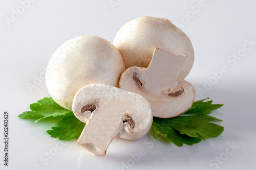 White champignon mushrooms on white background