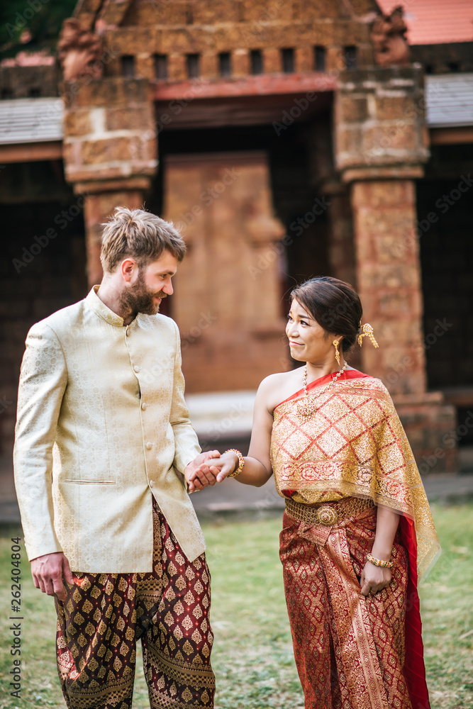 Asian bride and Caucasian groom have romantic time with Thailand dress