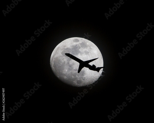 Airliner Passing in Front of a Full Moon