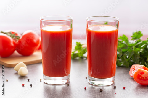 Wallpaper Mural Fresh tomato juice with parsley and spices, selective focus. Glasses with tomato juice and fresh tomatoes on a table  Torontodigital.ca