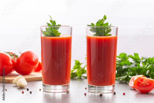 Wallpaper Mural Fresh tomato juice with parsley and spices, selective focus. Glasses with tomato juice and fresh tomatoes on a table  Torontodigital.ca