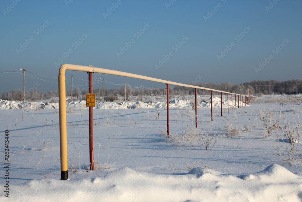 the yellow pipe for supply of liquefied gas is carried out in the Siberian settlement of Blagoe Novosibirsk region through snow in the winter the yellow pipe for supply of liquefied gas is carried out in the Siberian settlement of Blagoe Novosibirsk region through snow in the winter