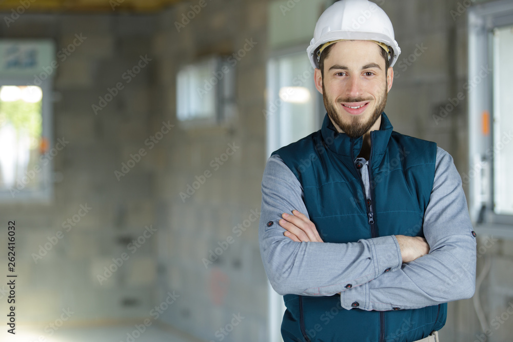 male professional engineer with tool belt posing with crossed arms male professional engineer with tool belt posing with crossed arms