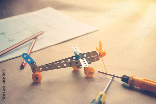Toy iron plane. Metal constructor with screwdrivers. Dream, play and create photo