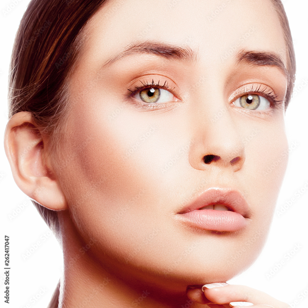 Gorgeous young model woman with perfect natural lips, clean skin and nude make-up touching chin, looking at camera Gorgeous young model woman with perfect natural lips, clean skin and nude make-up touching chin, looking at camera