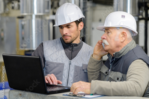 two engineer on maintenance checking technical data