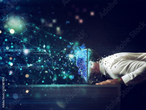 Businessman with his head inside a cyberspace through the laptop. Internet connection and addiction concept photo