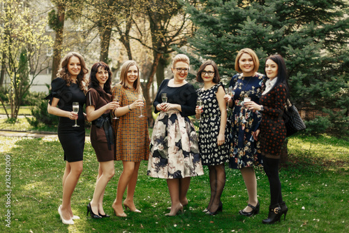 group of luxury elegant women celebrating and toasting with champagne, cheerful moment happiness