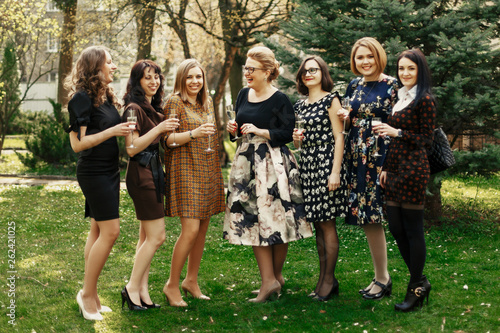 group of luxury elegant women celebrating and toasting with champagne, cheerful moment happiness