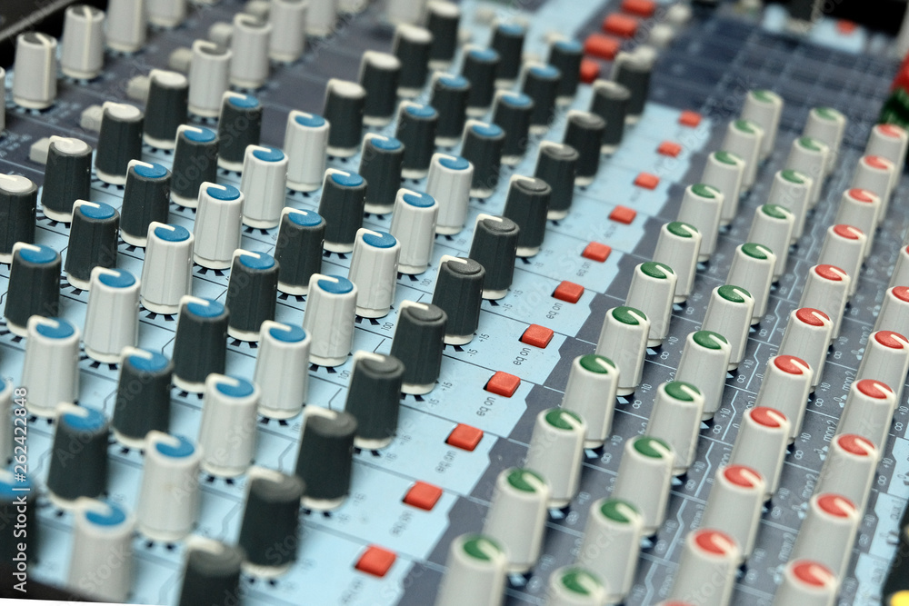 Mixing console close-up. Sound check for the concert. Mixer control. Music equipment and technology concept. Mixing console close-up. Sound check for the concert. Mixer control. Music equipment and technology concept.