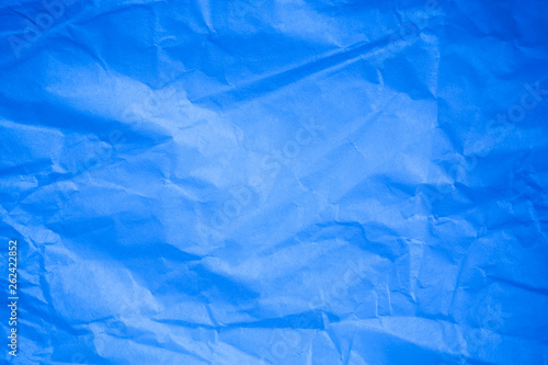 Crumpled blue paper background.