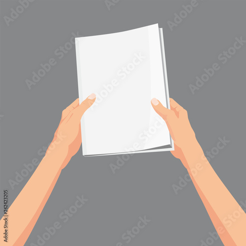 Hands holding a magazine, brochure book
