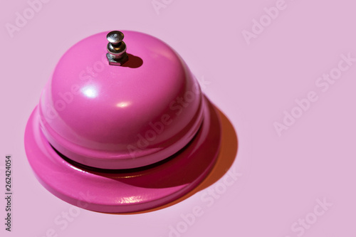 pink bell on red background