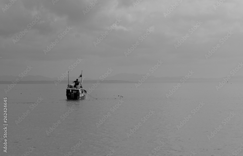 small fishing boat on calm seas
