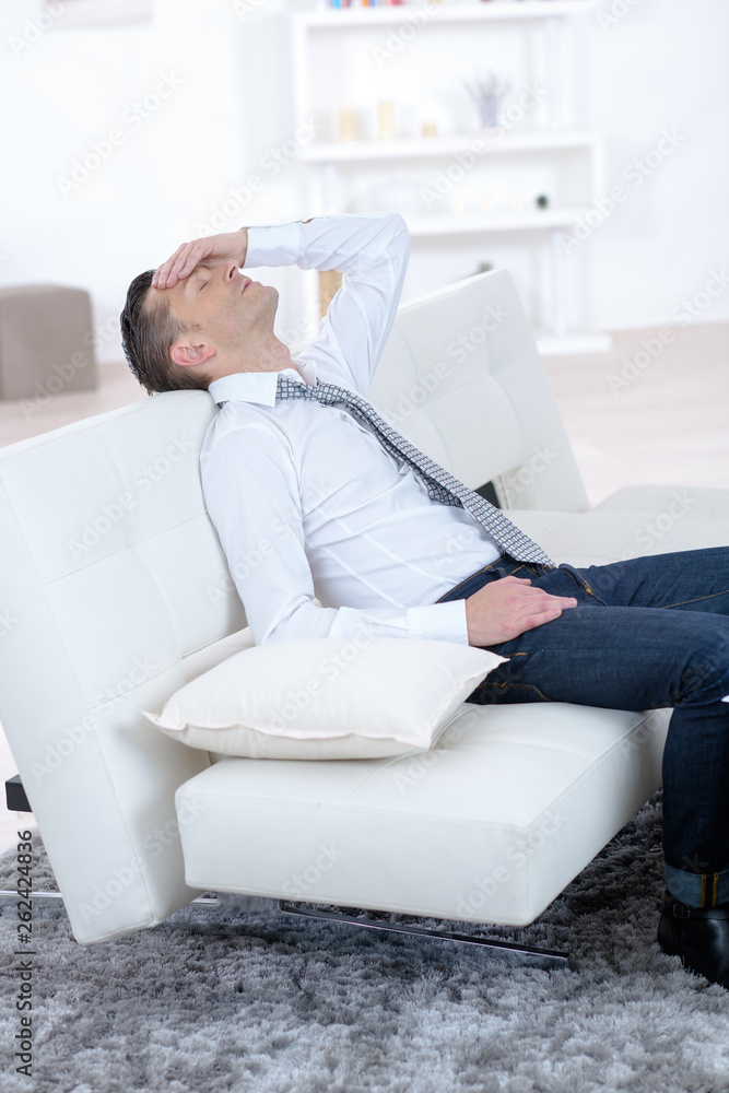 stressed businessman sleeping on the couch