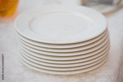A stack of white plates on the table