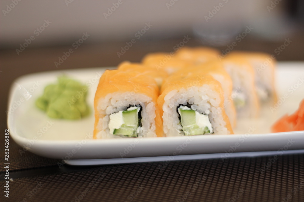 Delicious rolls with fish on a white plate Delicious rolls with fish on a white plate