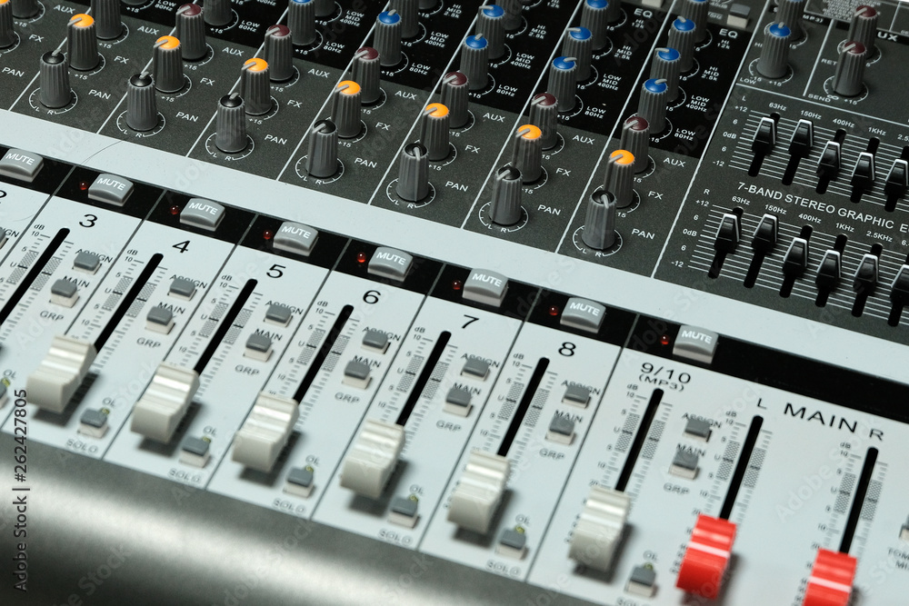 Mixing console close-up. Blurry. Sound check for the concert. Mixer control. The concept of music equipment and technology. Mixing console close-up. Blurry. Sound check for the concert. Mixer control. The concept of music equipment and technology.