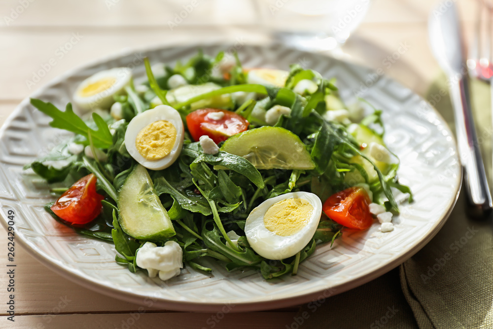 Tasty arugula salad on plate