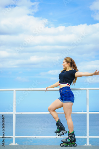 Girl wearing roller skates on seaside