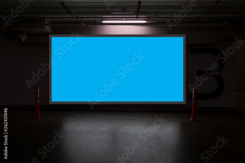 indoor car parking and empty blue billboard .Blank space for text and images.