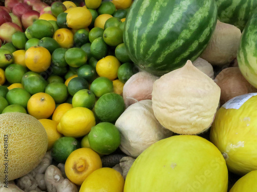 heap of fruit with lemons  lime  apples  melon and ginger