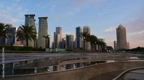 Early morning time lapse of Doha skyline with water feature in the foreground photo