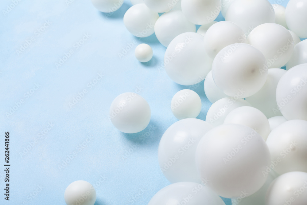 Pastel blue table with white balloons. Party or birthday background. . Pastel blue table with white balloons. Party or birthday background. .
