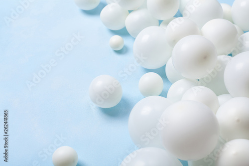 Pastel blue table with white balloons. Party or birthday background. .