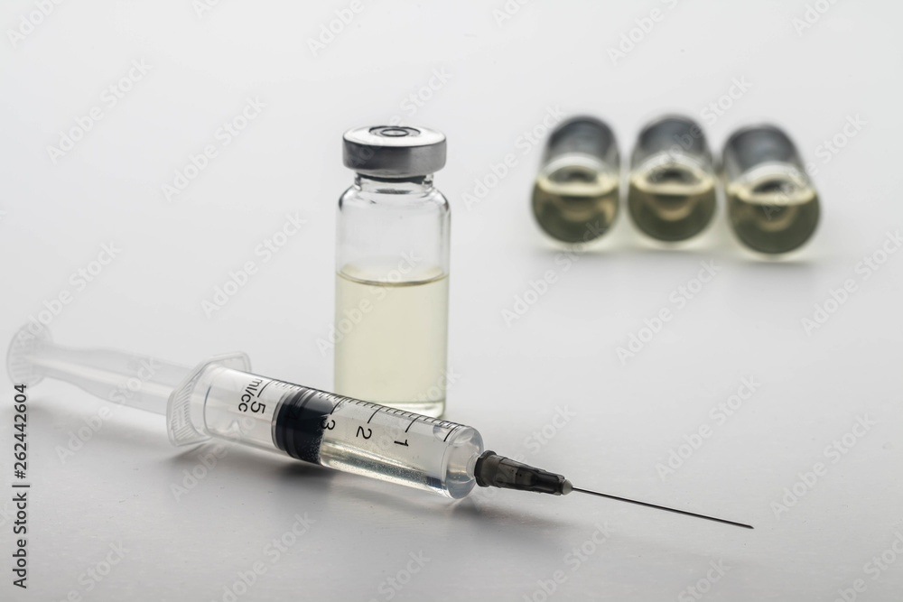 Subcutaneous syringe. Syringes with blue needles. Medical Injectors. Medical glass injection bottle. Ampoules with injections. Subcutaneous syringe. Syringes with blue needles. Medical Injectors. Medical glass injection bottle. Ampoules with injections.