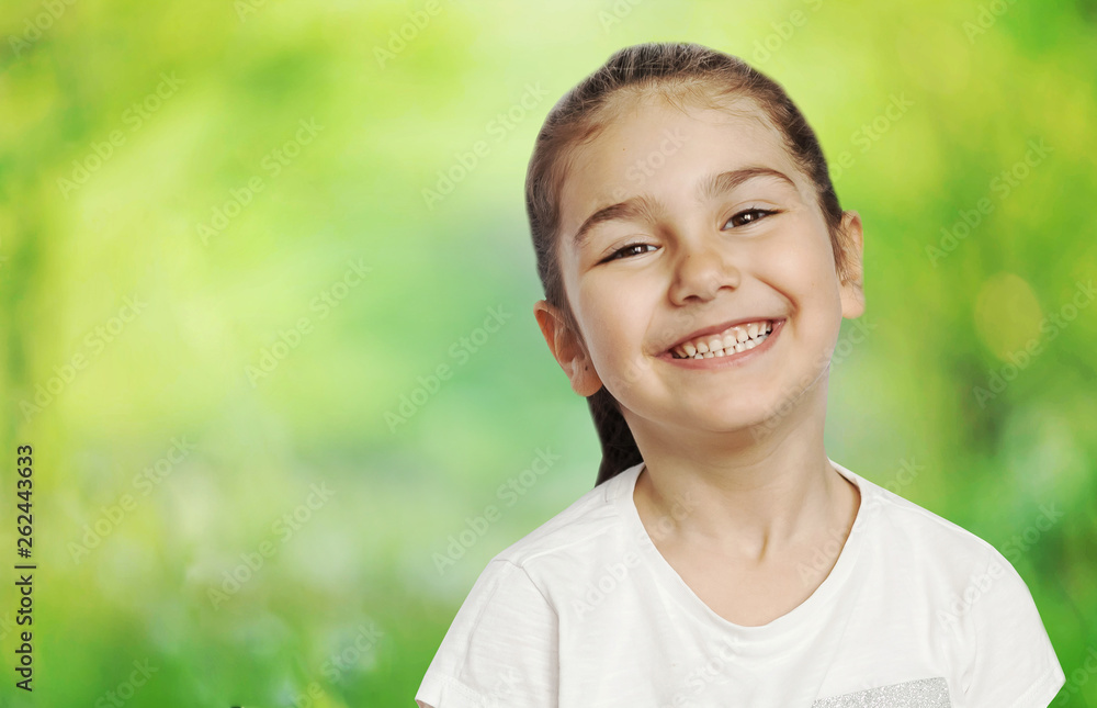 Happy cute child girl on the blur green background Happy cute child girl on the blur green background