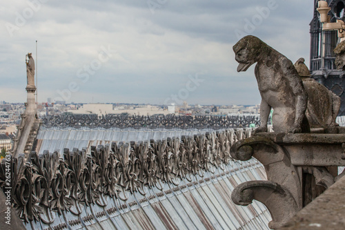 Famous Notre Dame gargoyle overlooking the Paris cityscape