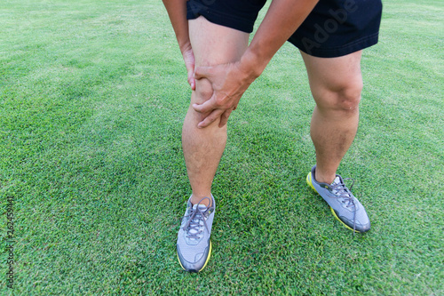 Tendon knee joint problems on Man's leg from exercise In the stadium. 